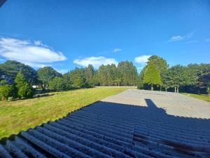 an empty amphitheater with a blue sky and trees at Alojamientos O Camiño in A Coruña
