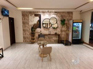 دار داكن للشقق المخدومة في الرياض: غرفة بها موقد وكراسي ومرآة