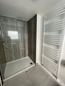 a shower with a glass door in a bathroom at 4@No.4. A cosy spot for 4 and one furry friend in Cawood