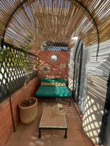 a small patio with a bench and a table at Dar Al Assad in Marrakesh