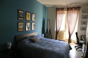 a blue bedroom with a bed and a window at Faber House in Venaria Reale