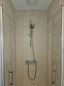 een douche met een glazen deur in de badkamer bij NERO studio confort tt équipé! in Villejuif