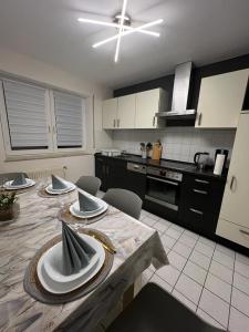 a kitchen with a table with plates on it at Ferienwohnung 24 Unten Rechts 3 Zimmer in Lathen