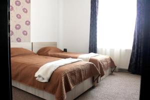 a bedroom with two beds and a window at Pension Daciana in Bacău