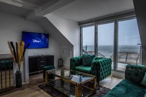 a living room with a couch and a glass table at River View Luxury Apartment in Littlehampton