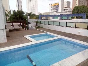 a swimming pool on the roof of a building at Apartamento Green Park in João Pessoa