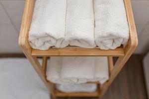 a towel rack with white towels on it at Deluxe Apartments 55 in Kranjska Gora +56 photos