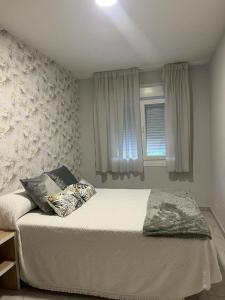 Ένα ή περισσότερα κρεβάτια σε δωμάτιο στο Apartamentos Camiños Chans