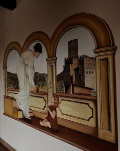 una pintura de un hombre en una cama con un niño en Residence Al Castello, en Trento