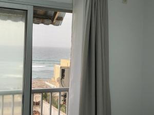a room with a window with a view of the ocean at ESPACE VIRAGE in Dakar