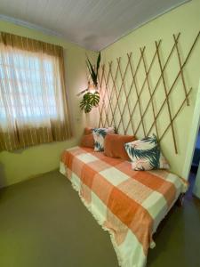 a bedroom with a bed and a window at Casa Saracura in Aguaçu