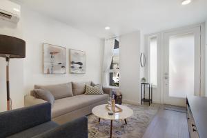 a living room with a couch and a table at Gorgeous NEW Townhome on Capitol Hill, Close to Everything! in Seattle