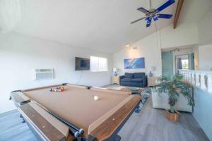 a pool table in a living room with a ceiling fan at Ocean View / Pool Table / Surfboards / Beach Bikes in Oxnard