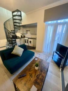 a living room with a couch and a coffee table at Self Contained 1 Bedroom Duplex in Leicester