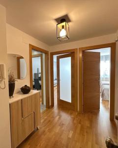 a living room with a wooden floor and a door at Studio 14 + garaje incluido. Nuevo, elegante, acogedor. in Haro