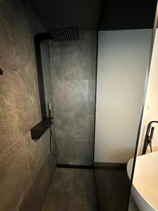 a shower with a glass door in a bathroom at woidpanorama ehemals Haus Heike in Neuschönau