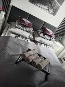 a bedroom with two beds with purple pillows at Willa La mer-Balia z jacuzzi, sauna ,klimatyzacja ,rowery in Ustka