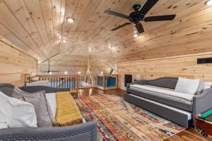 a living room with two couches and a ceiling fan at Brand New/ATV Trailer Parking/ 5 min to Miguel's in Rogers