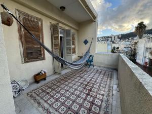 a balcony with a hammock on the side of a building at Lily’s house in Haifa