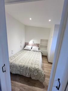 ein Schlafzimmer mit einem Bett in einem weißen Zimmer in der Unterkunft Menton Ciapetta in Menton