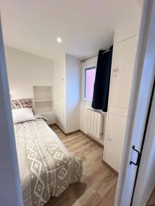 a small bedroom with a bed and a window at Menton Ciapetta in Menton