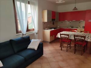a living room with a couch and a table in a kitchen at Appartamento a Colle Val d'Elsa in Colle di Val d'Elsa