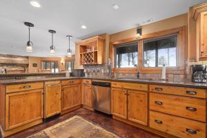 a kitchen with wooden cabinets and stainless steel appliances at Oak Haven On Leech Lake in Cass Lake
