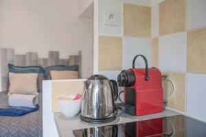 a coffee maker and a tea kettle on a counter at La Bougnate Proche des Thermes Royat/Chamalières in Chamalières