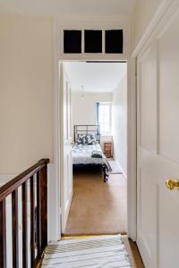un corridoio con un letto in una camera bianca di Morden House a Morden