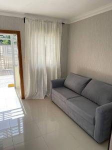a living room with a couch in front of a window at Apartamento de Lujo En San Pedro in San Pedro de Macorís