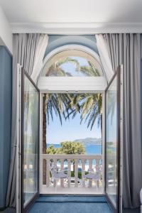 an open door to a balcony with a view of the ocean at Aminess Younique Korcula Heritage Hotel in Korčula