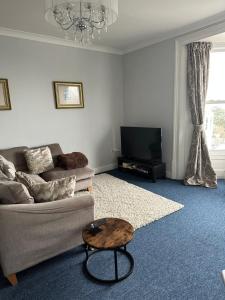 a living room with a couch and a coffee table at Stylish apartment in Walmer (nr Deal&Dover) in Walmer