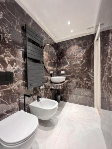 a bathroom with a white toilet and a sink at YLS Luxury Suites 2 in Milan