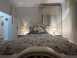 a bedroom with a large bed with two lamps at Presidential Apartment in Zamalek in Cairo