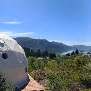 a tent sitting on top of a building with a view of a lake at Cabaña y Domos Ollagua con vista al lago in Cholila