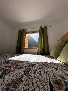 a bedroom with a bed and a window with a view at Casas cuevas, Los Cabucos in Agaete