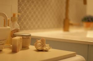 a bathroom counter with soap and a seashell on it at Lily’s house in Haifa
