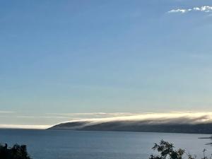 a large body of water with clouds in the distance at Seas The Day in Emu Bay