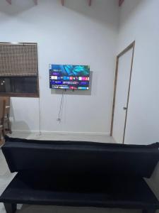 a flat screen tv hanging on a white wall at Casa Playa Loreto in Caldera