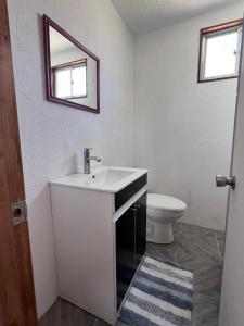 a bathroom with a sink and a toilet at Casa Playa Loreto in Caldera