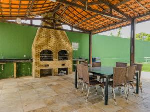 a patio with a table and a brick oven at Aloha Vibes Ap Cumbuco -Beach Place in Cumbuco