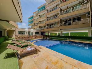 a swimming pool in front of a building at Aloha Vibes Ap Cumbuco -Beach Place in Cumbuco