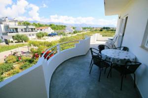 a patio with a table and chairs on a balcony at Apartments Orest in Sućuraj