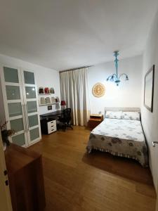 a bedroom with a bed and a desk at Casa di Ale in Verona