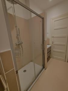 a shower with a glass door in a bathroom at Casa di Ale in Verona