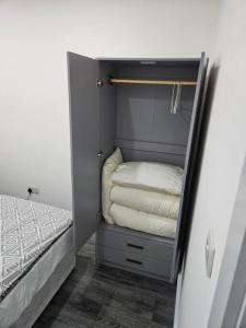 a closet with a bed and towels in it at Private One Bedroom Flat in Barnet, London in Finchley