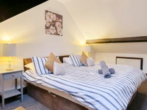 a bedroom with a large bed with blue and white sheets at 4-bed penthouse - Old Converted Church - FREE Parking in Pontypool