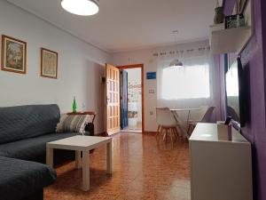 a living room with a couch and a table at Alhambra Apartments in Gran Alacant