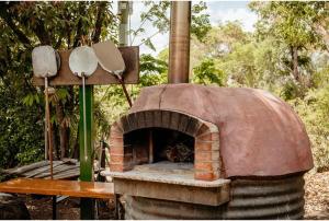 a brick oven with a wooden table and a table at Discovery Parks - Mount Surprise in Mount Surprise