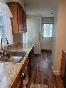 a kitchen with a sink and a counter top at Tranquil Retreat in the heart of Bethany 